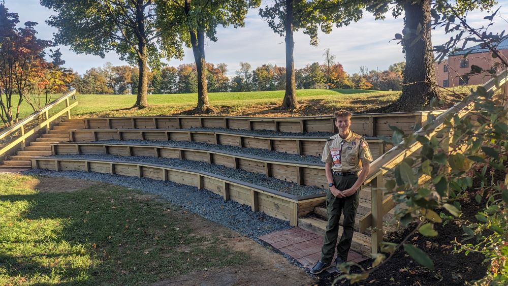 Student standing in front of outdoor classroom